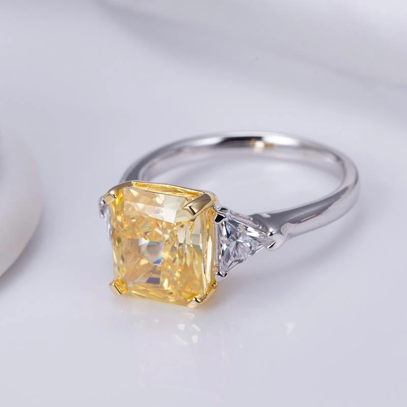 A finished ring with a yellow centre stone and contrasting pale metal band