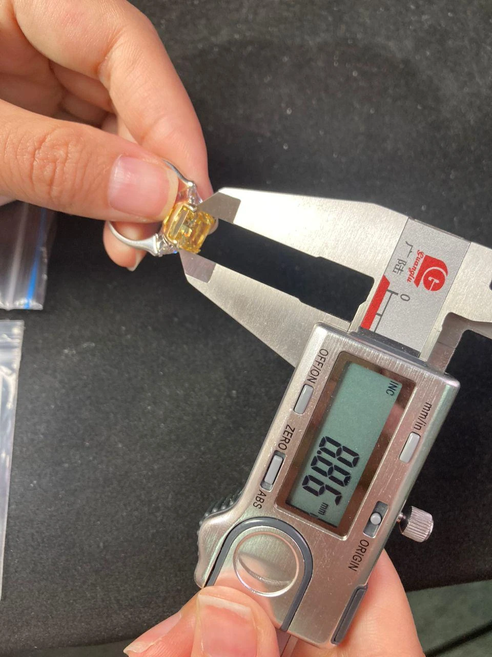 A digital caliper checking a yellow-centre ring